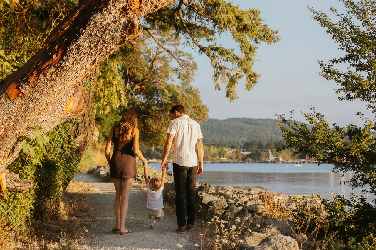 Family strolls along a peaceful seaside pathway
