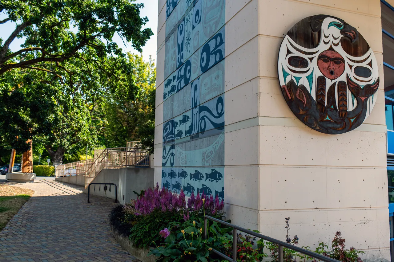Building with Indigenous Art and Trees in Background Outside