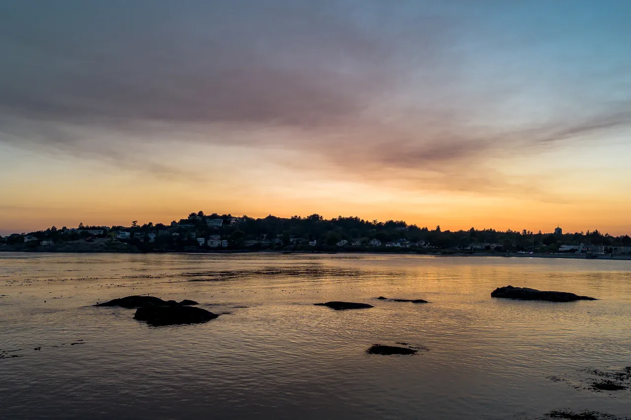 Ocean with Buildings and Skyline in Background at Dusk