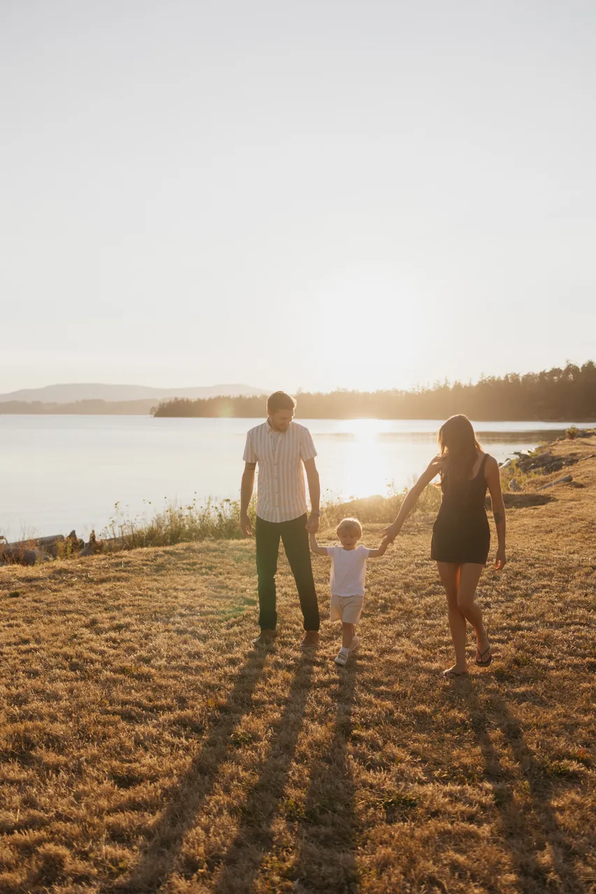 Family walking together along a golden coastal field