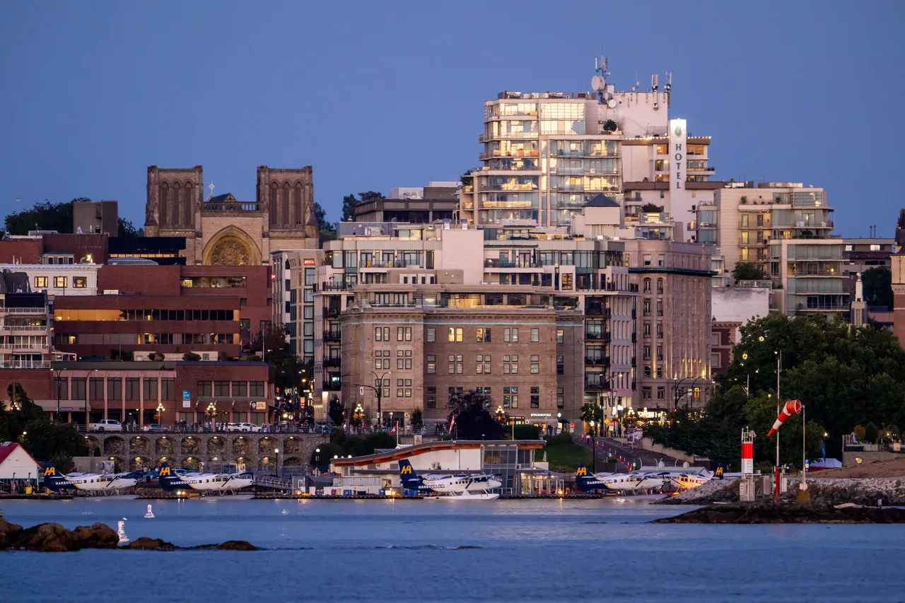 Downtown Victoria Harbour at Dusk with Planes and High Rise Buildings