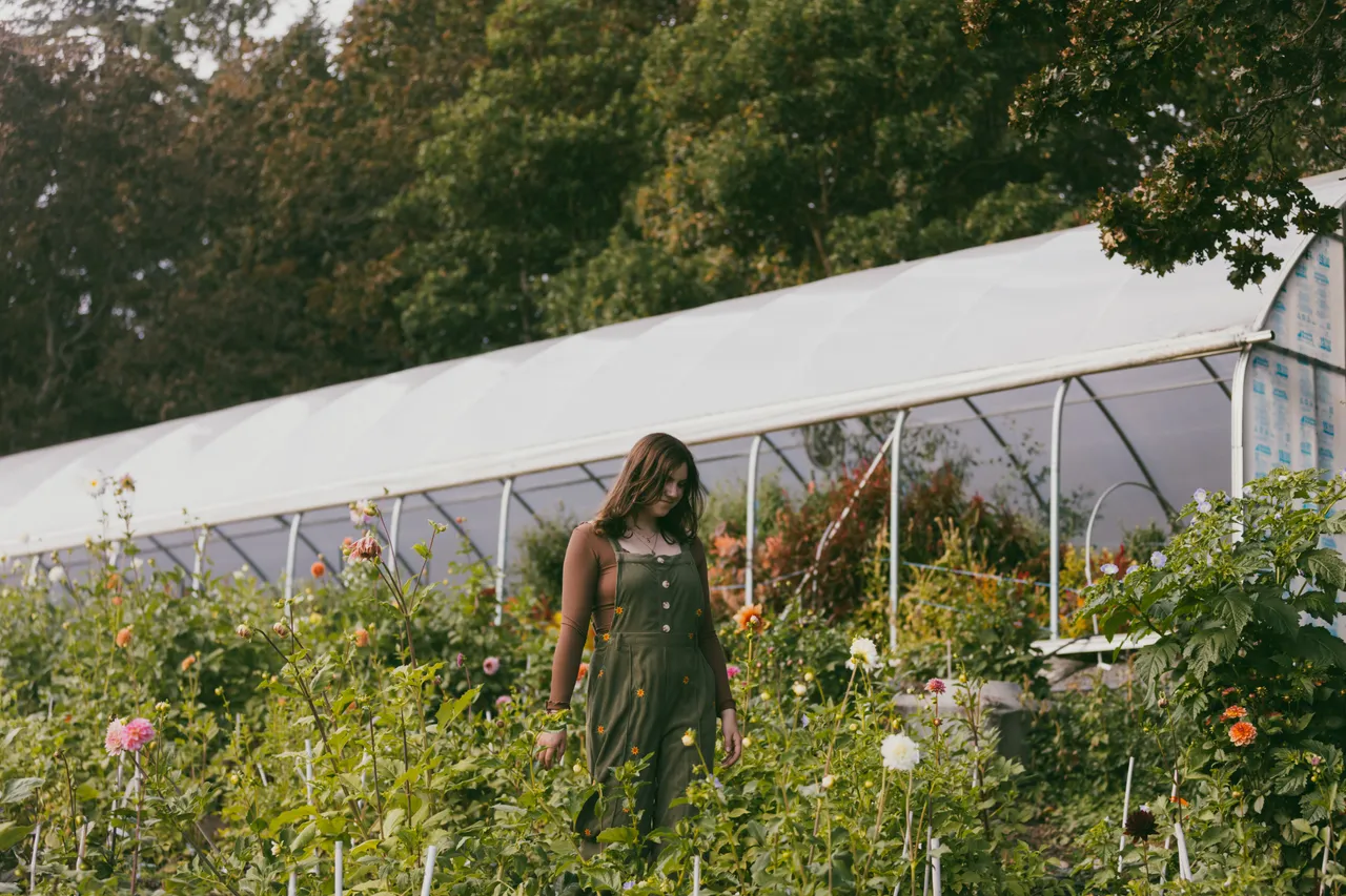 Woman walking through flower nursery - 1 - Twyla's Flower Farm