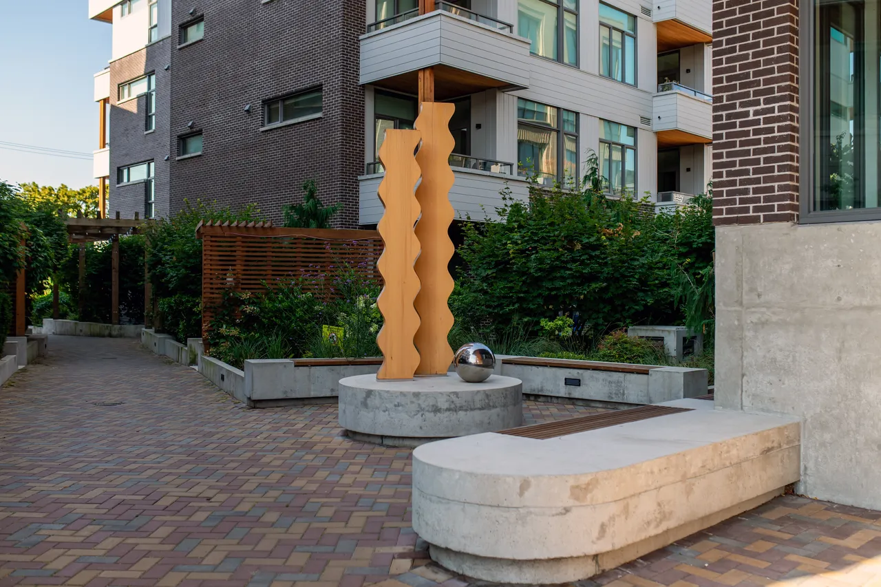 Wooden Art Structures near Apartment and Benches