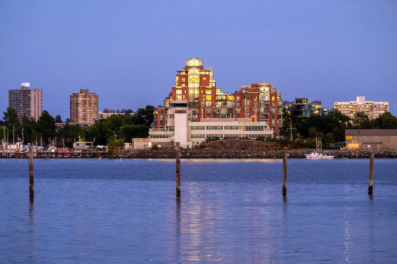 Downtown Victoria Photo overlooking Ocean with Boats and Tall Buildings at Dusk