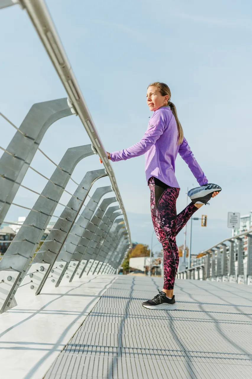 Woman stretching on bridge - 1