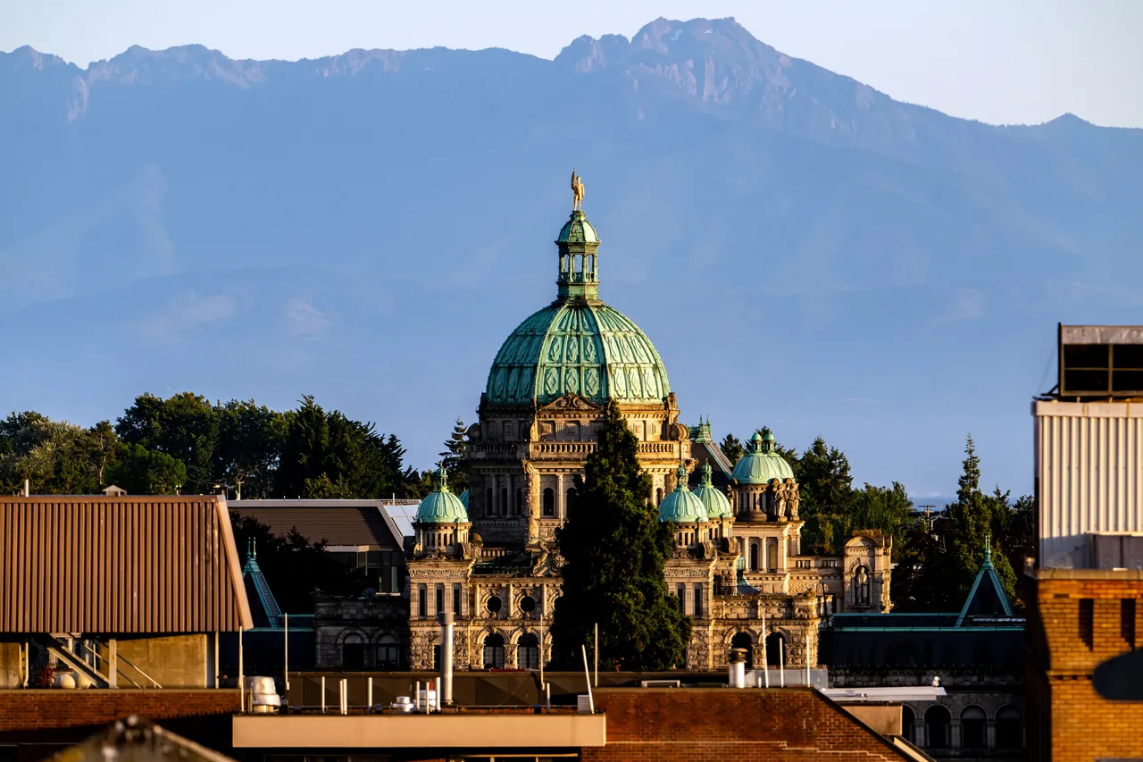 Parliament Buildings during Day with Mountains in Background