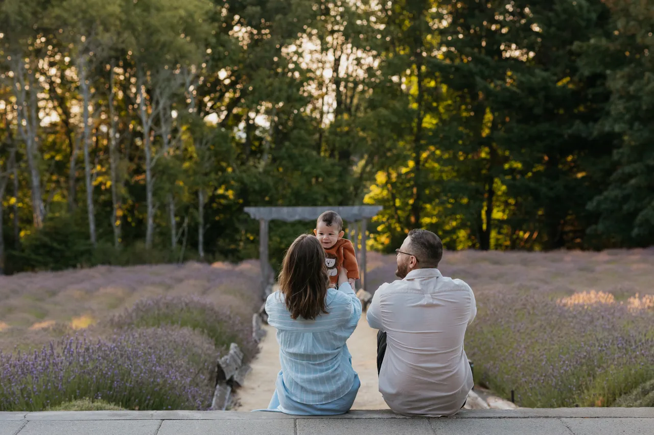 Family enjoys quiet moment in sunlit lavender fields
