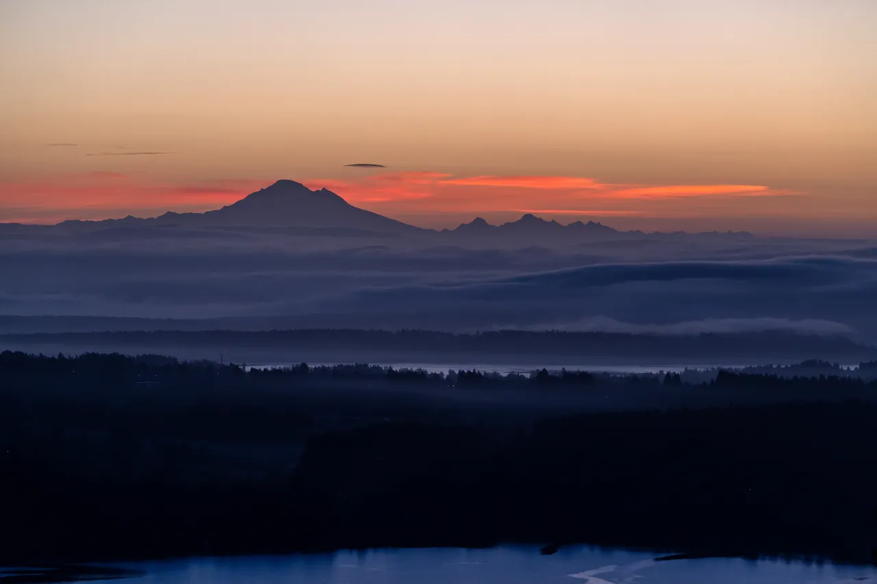 Cloudy Aerial Photo of Greater Victoria with Mountains and Red Clouds in the Background